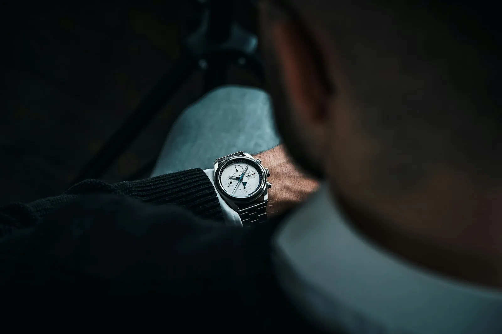A watch worn with a dark jacket